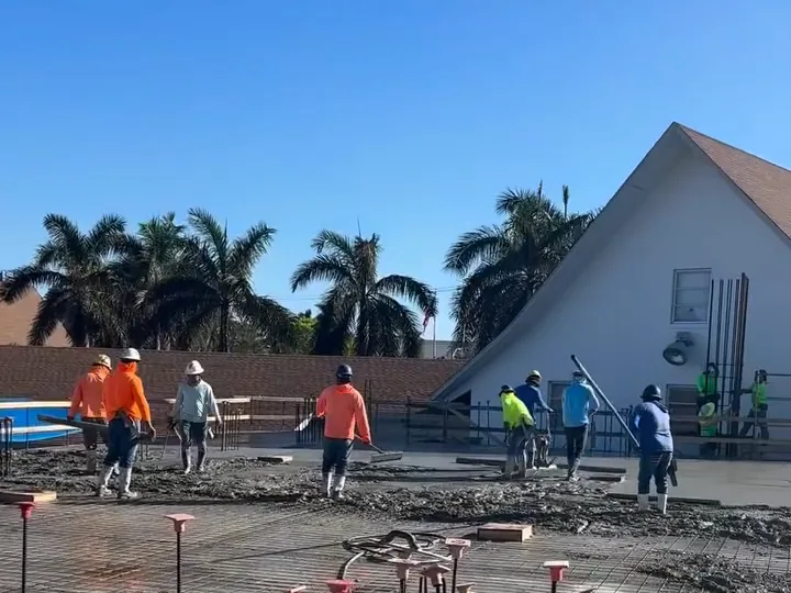 Crew pouring concrete on the new building’s deck