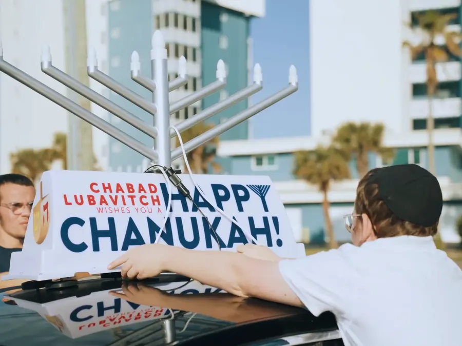 A menorah going up on a car roof